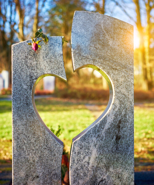 Tombstone with heart on graveyard