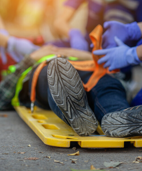 Selective focus shoe . Team paramedic firs aid accident on road. Ambulance emergency service. First aid procedure.