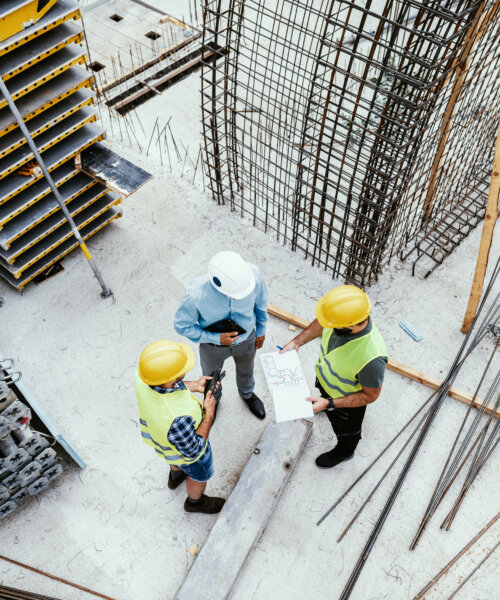 Candid shot of engineers and contractors on construction site