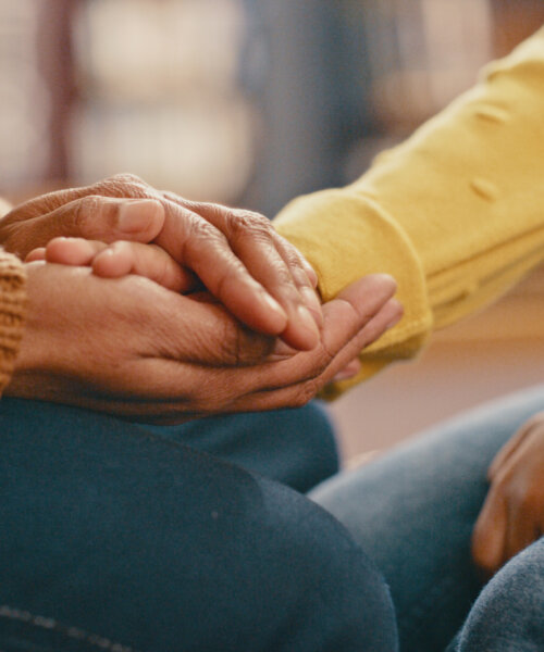 Hands, love and care touching in support, trust or unity for community, compassion or understanding. People holding hands in respect for loss, affection or passion for listening, talk or time