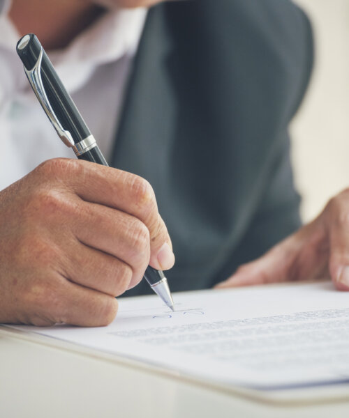 Asian business man using pen signing on new contract to starting projects in conference room. Close up manager businessman hands sign contract working meeting. Business agreement concepts.