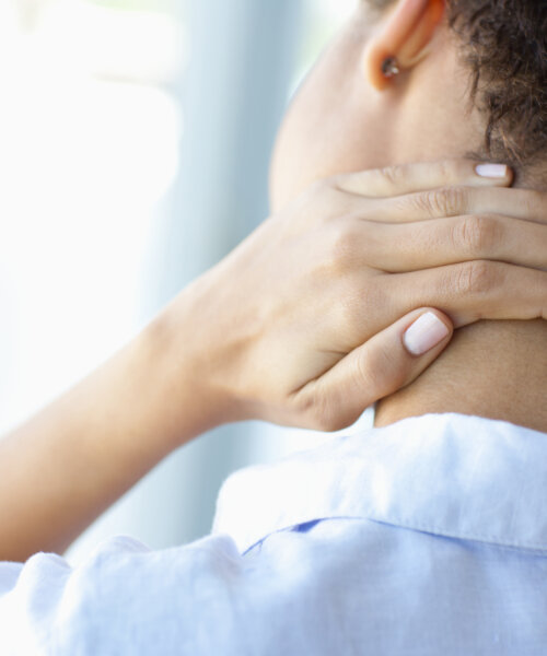 Woman rubbing sore neck