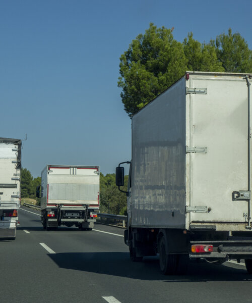 Merchandise transports. Overtaking trucks on the road.