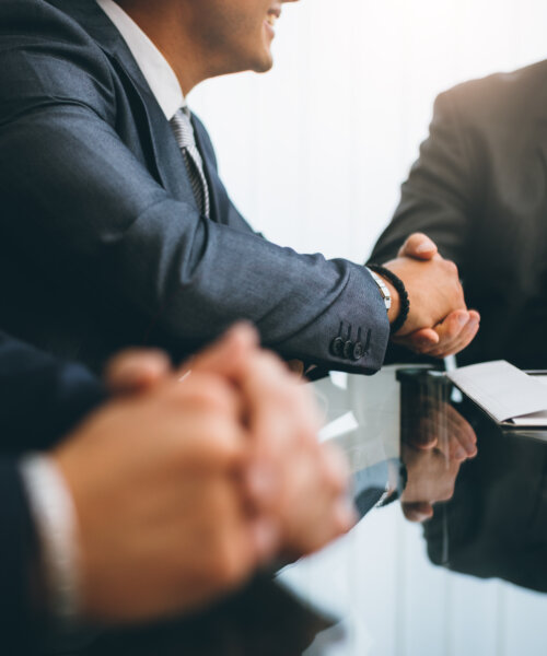 Business people shaking hands, finishing up a deal