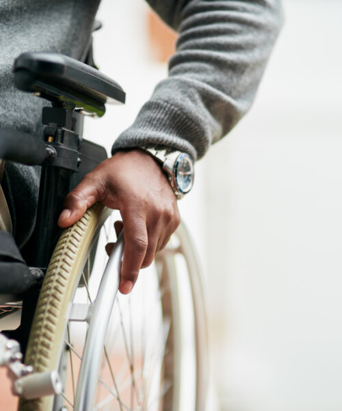 Cropped shot of an unrecognizable senior man sitting in his wheelchair at home