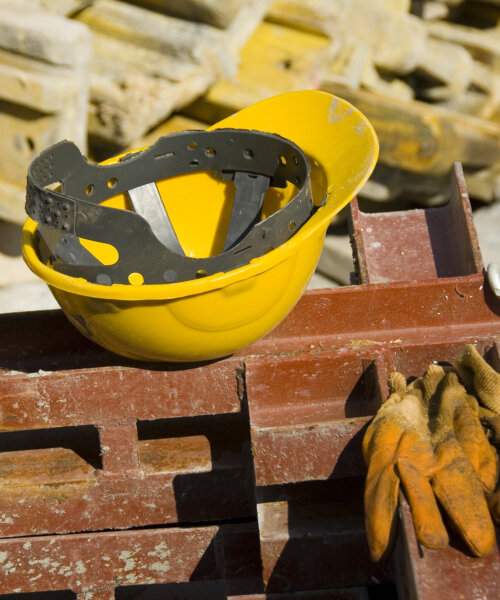 View of hard hat and gloves at construction site