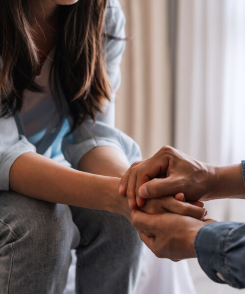 Young man comforting and supporting a sad woman who is grieving, Consolation and encouragement concept