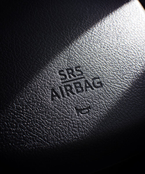 SRS Airbag icon on steering wheel in a car.