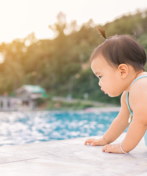 Baby infant tries to crawl down to the pool alone with danger.