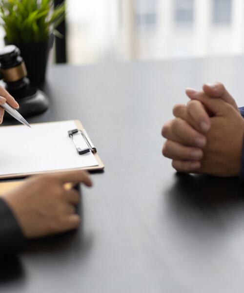 Businessman and lawyers discussing contract papers on wooden desk in office. Law, legal services, advice, Justice concept.