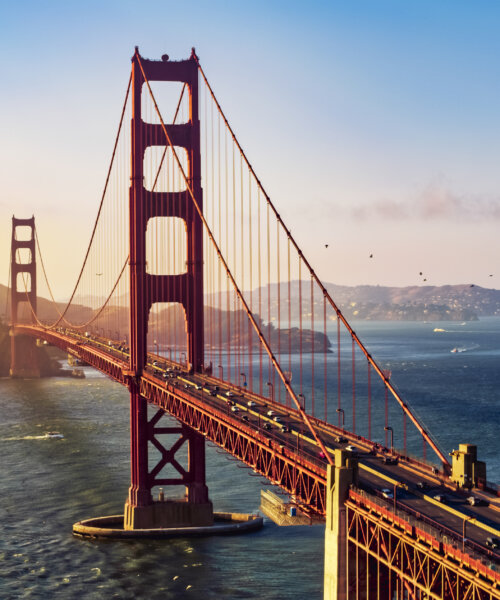 Aerial view of traffic moving on Golden Gate Bridge during sunset, San Francisco, California, USA.