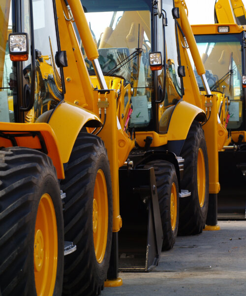 Diggers in a Row on Industrial Parking Lot