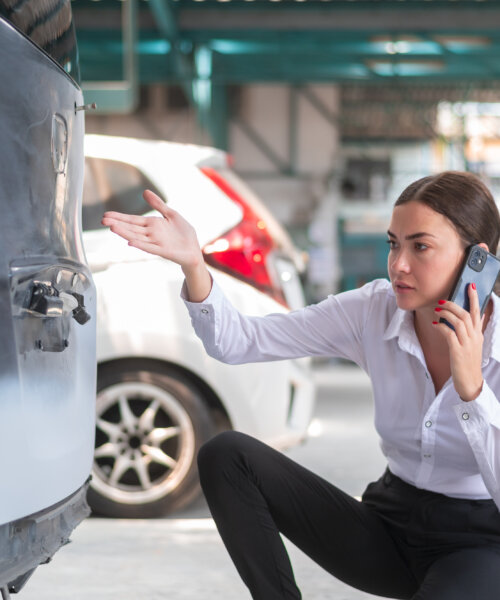 A young Caucasian woman calling mechanic service to repair her car feeling upset repair service