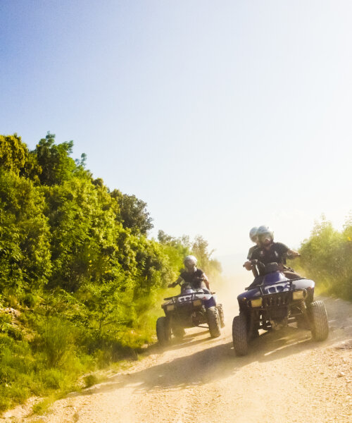 two guys on quad bikes on mountain trail