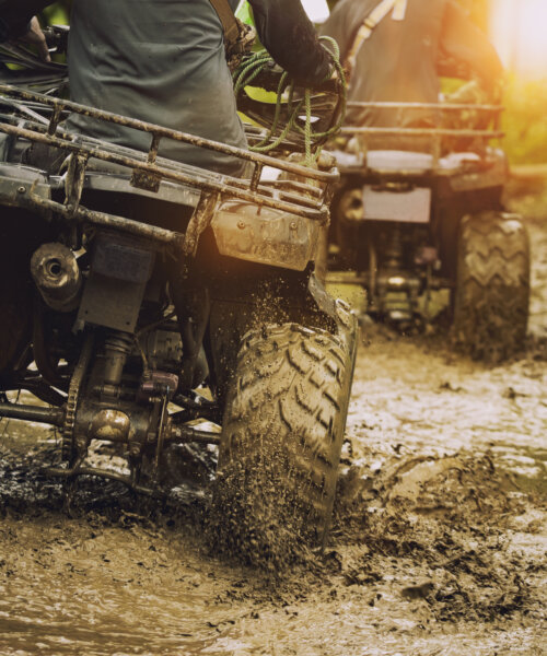 man riding atv vehicle on off road track