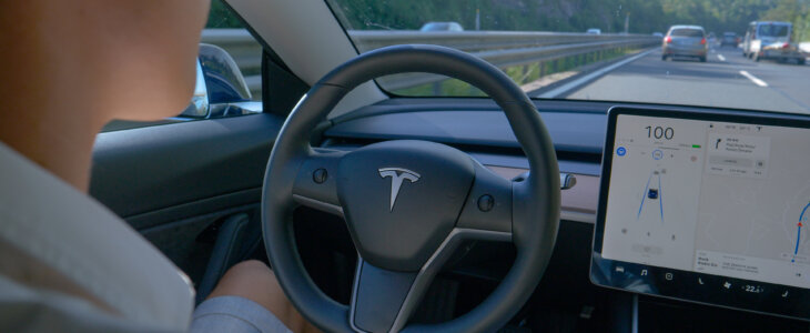 Man in front seat of self-driving car