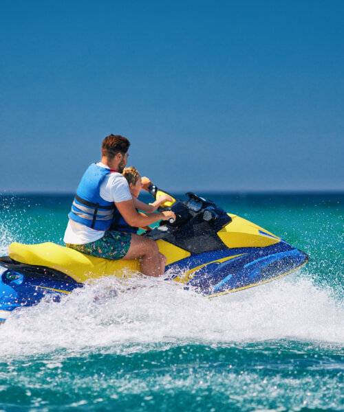 father and son having fun on jet ski