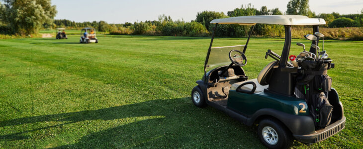 Golf car with golf clubs