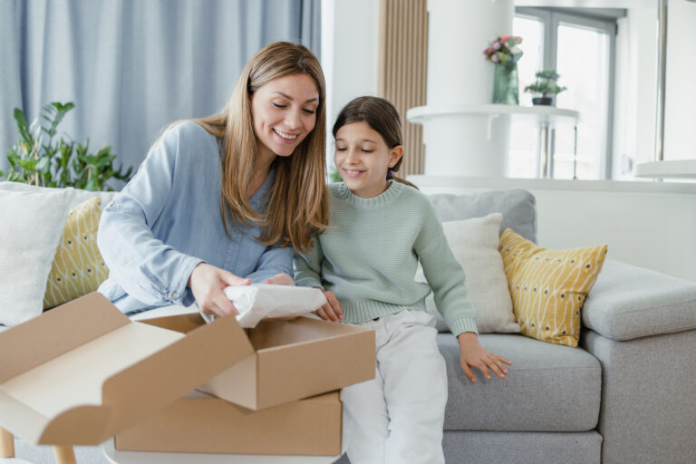 Cheerful mother and daughter excited to see their online purchase