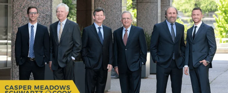 A group of six attorneys in suits standing outside an office building, representing Casper Meadows Schwartz & Cook, Bay Area injury attorneys.