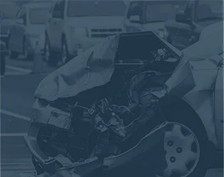 Car with severe front-end damage after a traffic accident on a busy road