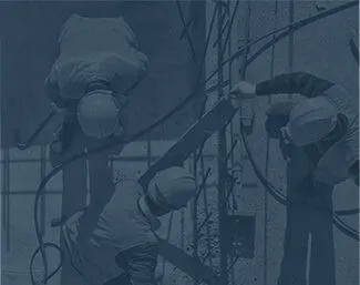Construction workers in safety gear handling cables and working on a concrete structure