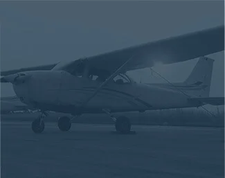 Small propeller airplane parked on a runway