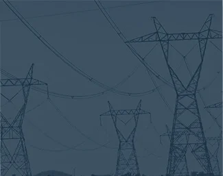 High-voltage power lines and transmission towers stretching across the landscape