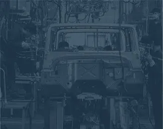 Automobile assembly line with workers building a vehicle frame