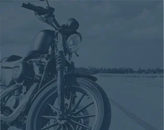 Motorcycle parked on an open road with sky and horizon in the background