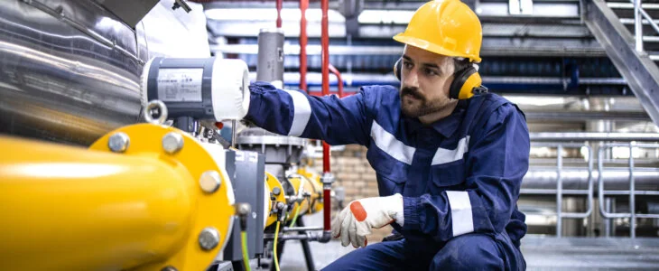 Industrial worker inspecting a pipeline