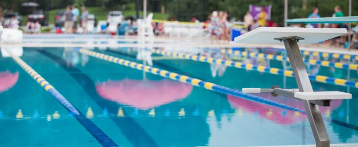 public swimming pool with people sitting in the distance