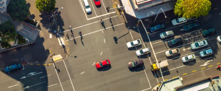 Aerial view of a busy intersection with cars and pedestrians