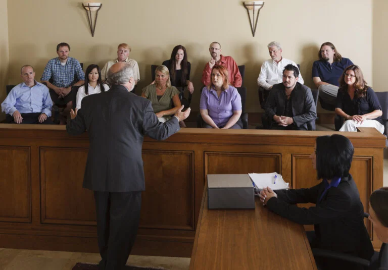 A lawyer in a courtroom talking to the jury.